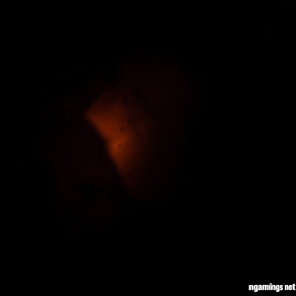 Dark low-key photograph of a warmly lit desk with a notebook and pen, deep shadows across the scene, intimate and inviting mood